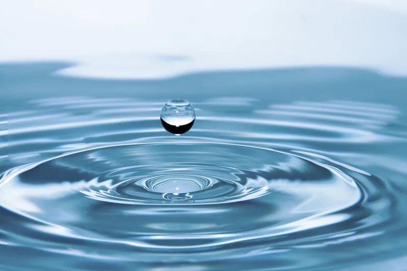 A drop of water landing in water